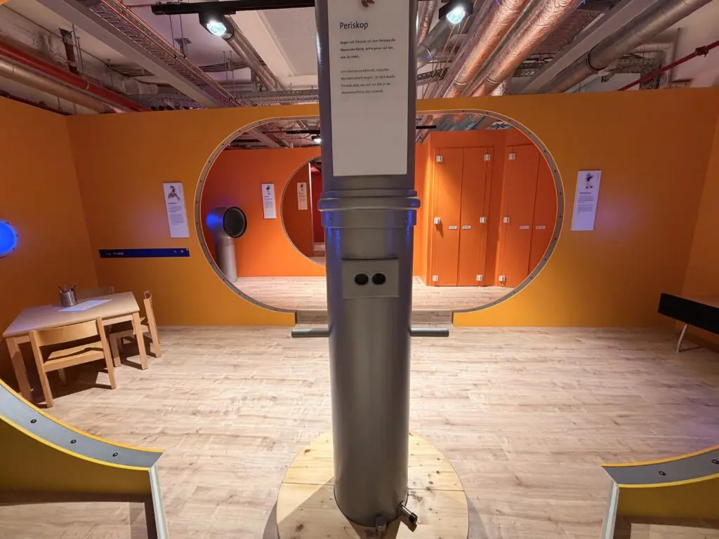 AOK U-Boot Gesundheitszentrum für Kinder mit Periskop, runden U-Boot-Durchgängen und spielerischer Raumgestaltung.